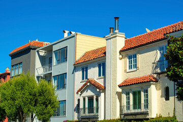 Fototapeta na wymiar Row of houses or townhomes in downtown city in san francisco california with blue sky copy space sky