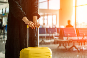 Traveling girl with a suitcase at the airport. Vacation, planes, flights, travel concept.