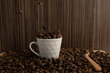 White coffee mug filled with coffee beans