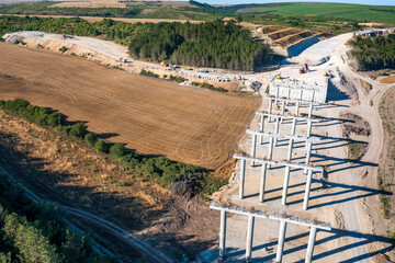 Fototapeta premium Construction of a new road and bridge.Concrete new bridge supports.