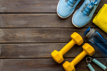 Sport fitness flatlay with sneakers and dumbbells, top view