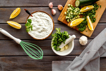 Greek dip sauce ingredients - sour cream with herbs cucumber
