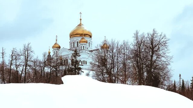 Belogorsky St. Nicholas Orthodox Missionary Monastery. Russia, Perm Krai, Belaya Gora. The temple on the hill in winter. Monastery on the background of snow. 4K