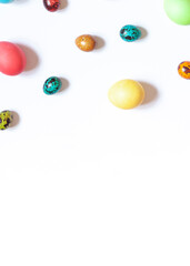 Colorful painted Easter eggs on the white background. Top view. Copy space