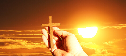 Good Friday concept. Cross in arm on sky background.