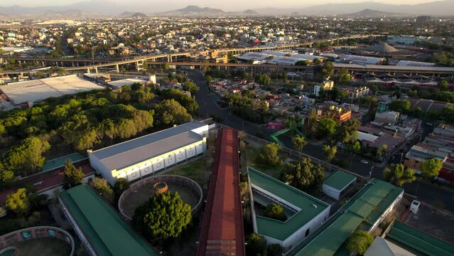 drone shot of freeways and historical lecumberri prison in mexico city during sunset