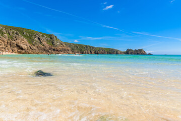 Obraz premium Porthcurno beach, picturesque retreat featuring turquoise waters, surrounding granite cliffs and golden sand. Cornwall, England UK