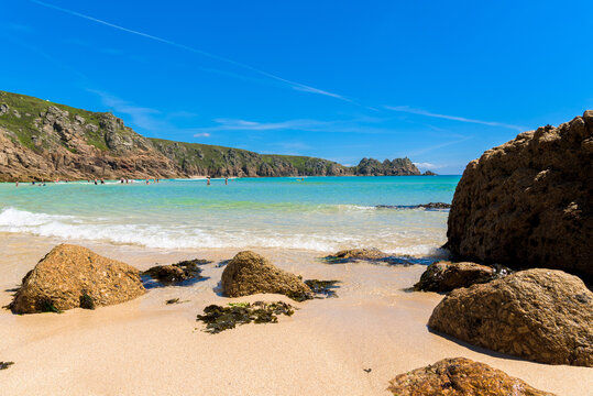Porthcurno beach, picturesque retreat featuring turquoise waters, surrounding granite cliffs and golden sand. Cornwall, England UK