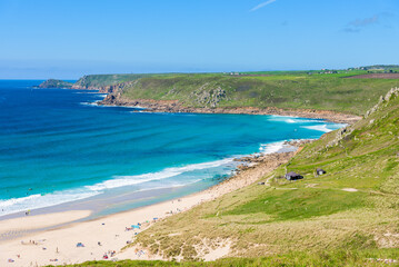 Sennen Cove beach and Cape Cornwall, beautiful bay with crystal clear turquoise water. Popular spot for surfing. England, UK.