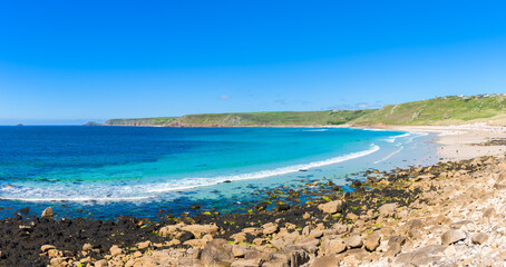 Fototapeta na wymiar Sennen Cove beach and Cape Cornwall, beautiful bay with crystal clear turquoise water. Popular spot for surfing. England, UK.