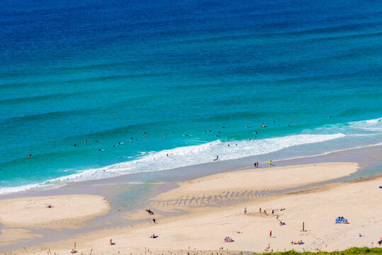 Sennen Cove beach and Cape Cornwall, beautiful bay with crystal clear turquoise water. Popular spot for surfing. England, UK.