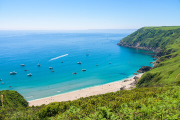 Fototapeta na wymiar Stunning coastline and beach at Lantic Bay. Crystal clear turquoise sea water in Cornwall, England.