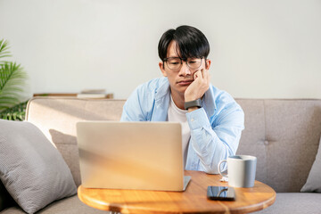 Businessman in casual is sitting comfortable sofa while using la