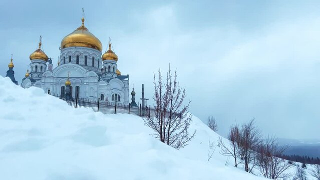 Belogorsky St. Nicholas Orthodox Missionary Monastery. Russia, Perm Krai, Belaya Gora. The temple on the hill in winter. Monastery on the background of snow. 4K
