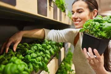 Young woman buying herbs in the supermarket