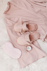Flat lay composition with house slippers, sleeping mask and pajamas on light background