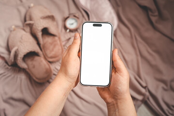 Phone with an isolated screen on the background of home clothes, a place for your text