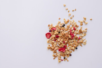 Granola on spoon isolated on white background, copy space. Healthy snack or breakfast concept - homemade granola.