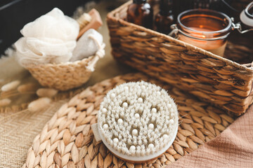 Cozy SPA setting ready for spa treatment or relaxation massage with the natural brush and massage oil / SPA background