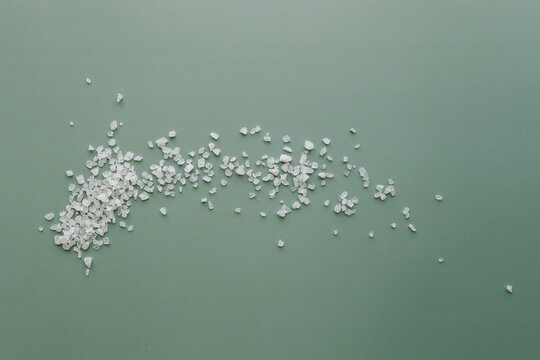 aromatic white Himalayan sea salt on green background. Homemade Herbal bath salts. Skincare spa beauty bath cosmetic products for relax. Natural skin care. Top view, copy space. Home spa. Aromatherapy