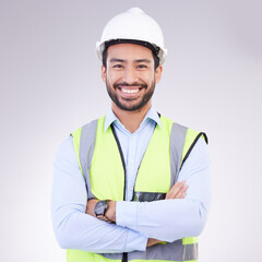 Construction worker in portrait, man with crossed arms and smile, architect or engineer in building industry on studio background. Happy male contractor, mockup and professional builder with helmet