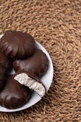 Photo of several whole chocolate marshmallows and one broken marshmallow