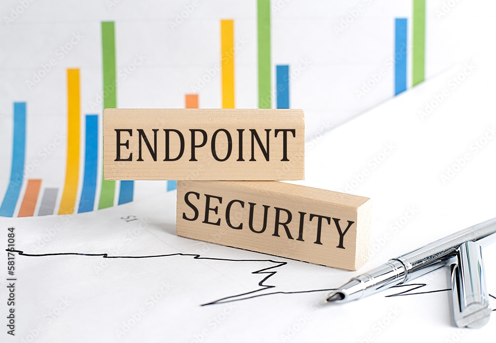 Aufkleber endpoint security text on notebook with pen and pencil on grey background