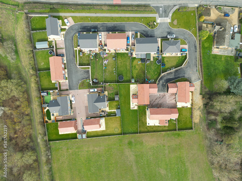 Wall mural top down drone view of a small housing development at the edge of an east anglian village. both priv