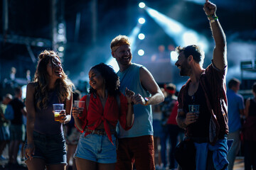Fototapeta premium Group of happy friends dancing at festival outdoors