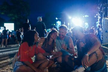 Young friends enjoying together a music festival