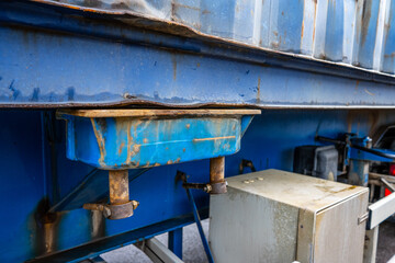 Container locking pin on a blue trailer.