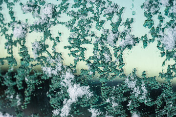 Frozen snow on a car window.