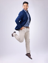 Jump, happy and portrait of man in studio with positive mindset, happiness and joy on white...