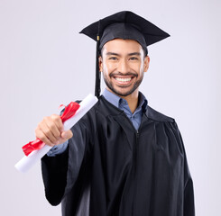 Graduate man, studio portrait and diploma in hand for learning achievement, education or goal by background. Happy student, certificate or smile for success, award and excited for college graduation