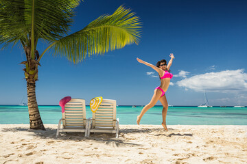 Carefree young woman relaxing on tropical beach. Saona Island, playa Punta Cana, Dominican,...