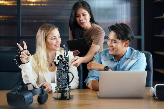 Group team work programer and engineer working AI robot arm system.  Business people Start-up production process technology and logic control constructing arm system project