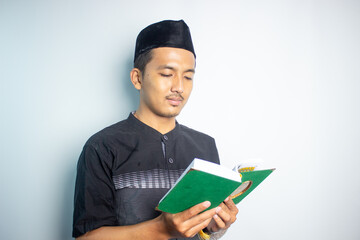 Asian muslim man are reading the quran book	
