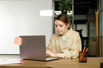 Shot of an attractive businesswoman working on laptop in her workstation