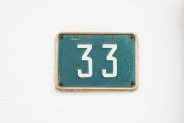 Finding Home: The Simple Elegance of a House Number Sign Displaying No. 33