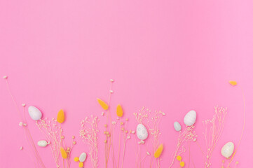 Happy Easter Holiday. Banner or greeting card background with Easter eggs and Flowers .Composition with Easter eggs and pink background. Flat lay, top view, copy space. 
