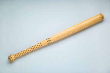 Wooden baseball bat on light grey background, top view. Sports equipment