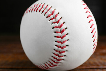 Baseball ball on wooden table, closeup. Sportive equipment