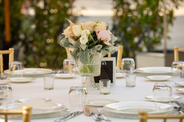 Wedding reception or other outdoor festive event. Luxury wedding reception dining table and gold...