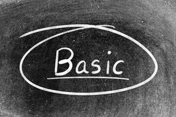 White chalk hand writing in word basic and circle shape on blackboard background