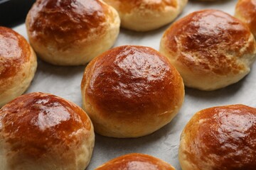 Freshly baked soda water scones on parchment paper, closeup
