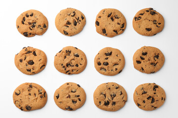 Many delicious chocolate chip cookies on white background, flat lay