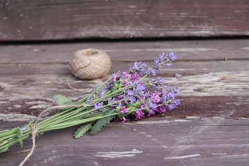 Composition of Betonica officinalis, common names betony, purple betony, isolated on wooden background. Top view, creative flat layout. The concept of summer, spring, mother's day.Medicinal plants.