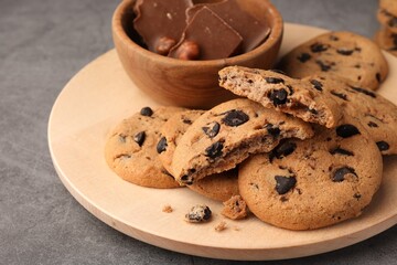 Delicious chocolate chip cookies on grey table, closeup