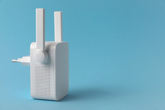 New modern Wi-Fi repeater on light blue background, space for text