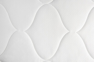 Clean white mattress as background, top view. After use of fabric shaver